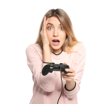 Emotional young woman playing video games with controller isolated on whiteの写真素材
