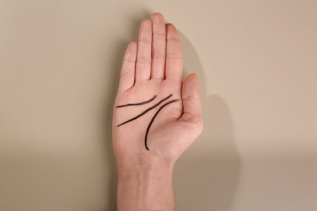 Woman showing palm with drawn lines on color background, top view. Chiromancy and foretellingの写真素材