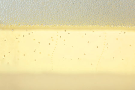 Close up view of champagne with bubbles as backgroundの写真素材