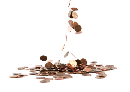Coins falling down into pile isolated on white