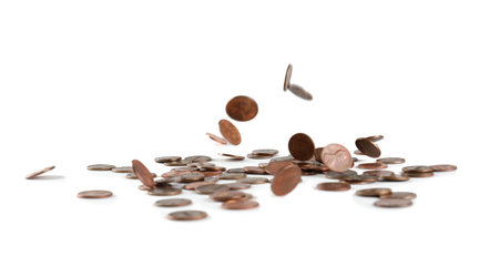 Coins falling down into pile isolated on whiteの写真素材
