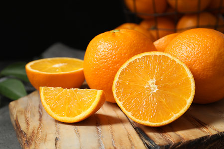 Wooden board with ripe oranges on table, closeupの写真素材