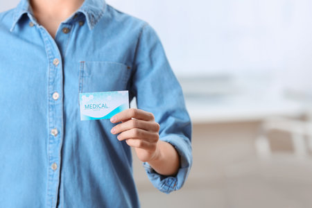 Woman holding business card indoors, closeup with space for text. medical serviceの写真素材