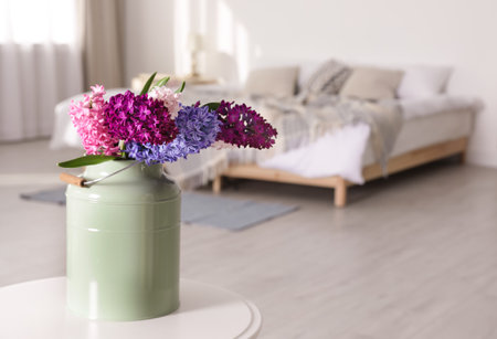 Beautiful hyacinths in metal can on table indoors, space for text. spring flowersの写真素材