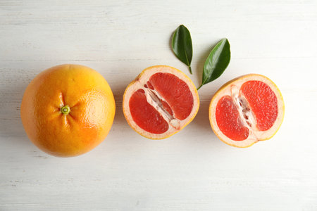 Fresh tasty grapefruits on wooden background, top viewの写真素材