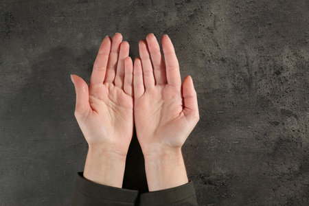 Woman showing palms at table, top view with space for text. Chiromancy and foretellingの写真素材