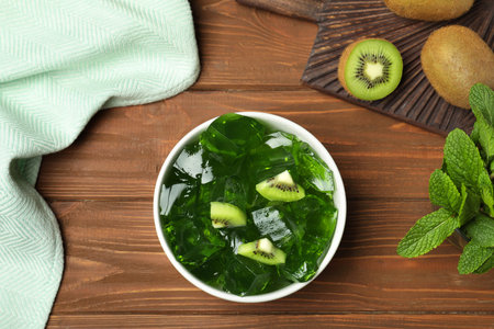 Flat lay composition with bowl of tasty jelly on tableの写真素材