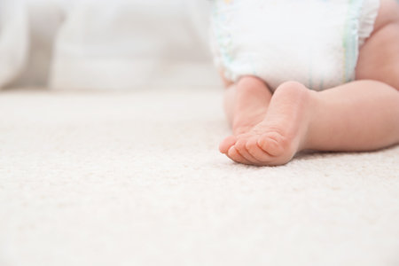 Cute little baby crawling on carpet indoors, closeup with space for textの写真素材