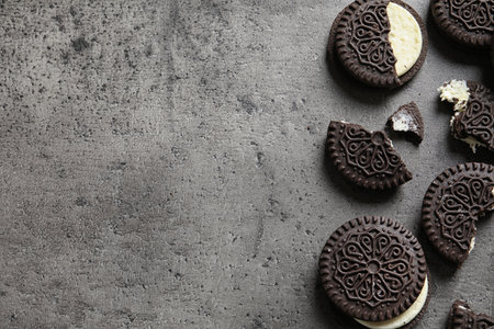 Tasty chocolate cookies on gray background, flat lay with space for text