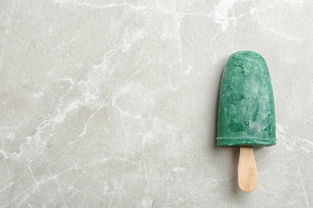 Delicious spirulina popsicle on gray background, top view. Space for textの写真素材