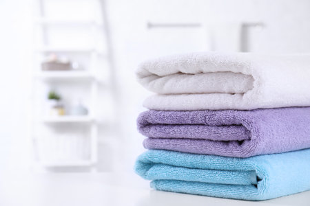 Stack of fresh towels on the table in the bathroom. Space for textの写真素材