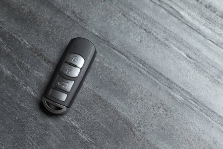 Car smart key on gray background, top view with space for textの写真素材