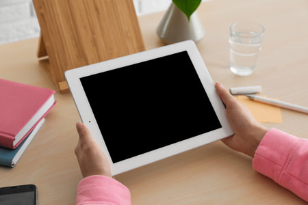 Woman using tablet at table, closeup. space for designの写真素材