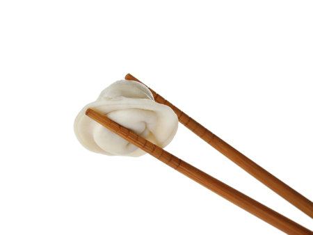 Chopsticks with tasty dumpling isolated on whiteの写真素材