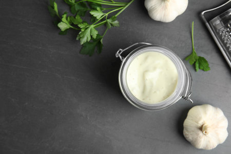 Flat lay composition with garlic sauce on gray background. Space for textの写真素材