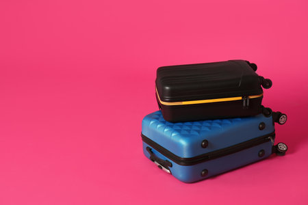 Stylish suitcases on color background. Space for textの写真素材