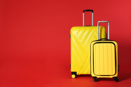 Stylish suitcases on color background. Space for textの写真素材