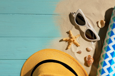 Flat lay composition with beach objects, sand and space for text on wooden backgroundの写真素材