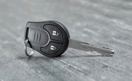 New modern car key on gray background
