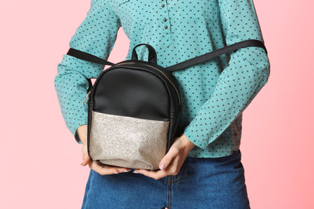 Fashionable woman with backpack on color background, closeupの写真素材