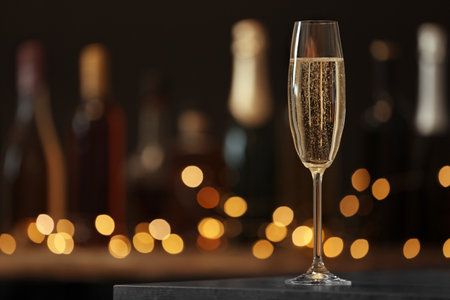 Glass of champagne on table against blurred background. Space for textの写真素材