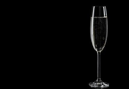 Glass of champagne on black background, space for textの写真素材