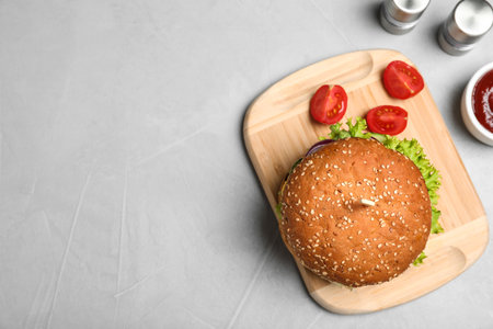 Flat lay composition with tasty burger on table. Space for textの写真素材