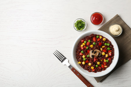 Bowl with cooked brown rice served on table, top view. Space for textの写真素材