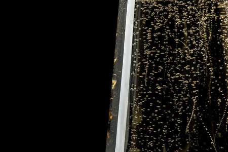 Glass of champagne on black background, closeup. Space for textの写真素材