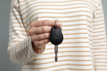 Young woman holding new car key, closeupの写真素材