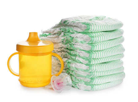 Stack of disposable diapers and baby accessories on white backgroundの写真素材