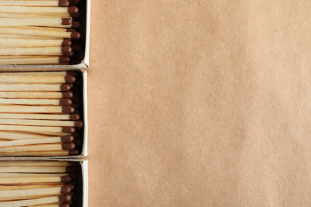 Flat lay composition with matches and space for text on craft paper