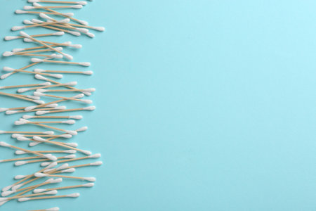Flat lay composition with cotton swabs and space for text on color backgroundの写真素材