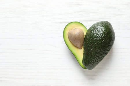 Fresh avocado on wooden background, top view with space for text. heart health dietの写真素材