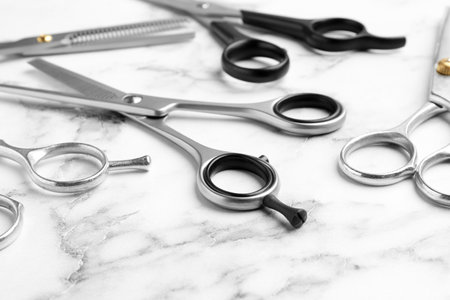 Many scissors on marble background. hairdresser toolsの写真素材