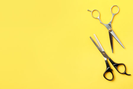 Flat lay composition with scissors and space for text on color background. hairdresser toolsの写真素材