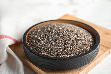 Plate with chia seeds on wooden boardの写真素材