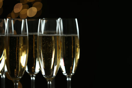 Glasses of champagne on blurred background, closeup. Space for textの写真素材