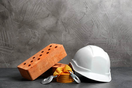 Composition with construction tools on gray table, space for text