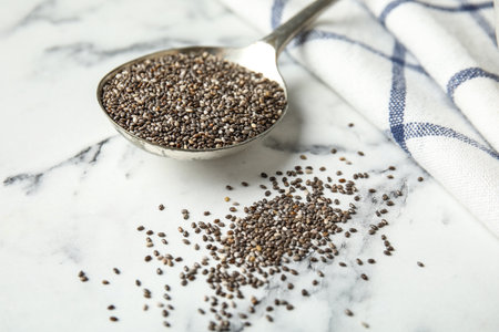 Spoon with chia seeds on marble table, closeupの写真素材