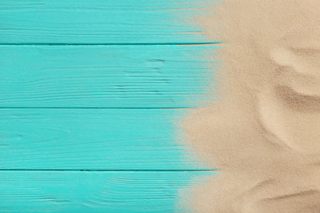 Beach sand on wooden background, top view with space for text