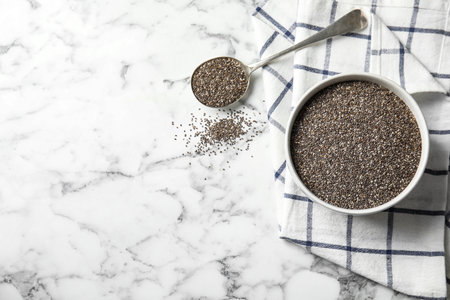 Flat lay composition with chia seeds on marble background, space for textの写真素材