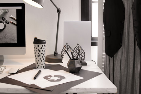 Stylish workplace with pencil holder and papers on deskの写真素材