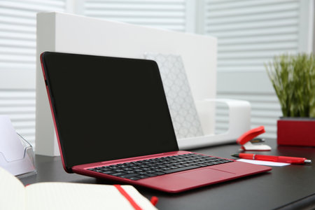 Stylish workplace with modern laptop on deskの写真素材