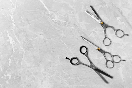 Flat lay composition with scissors and space for text on light background. hairdresser toolsの写真素材