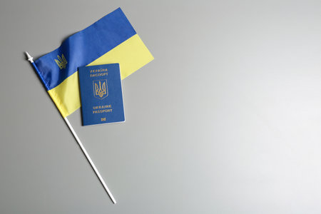Ukrainian travel passport and national flag on gray background, top view with space for text. international relationshipsの写真素材