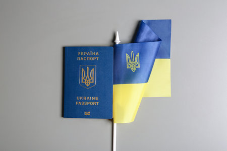 Ukrainian travel passport and national flag on gray background, top view. international relationshipsの写真素材