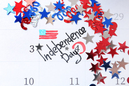 Composition with calendar and colorful confetti. USA Independence Dayの写真素材