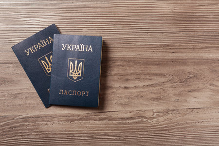 Ukrainian internal passports on wooden background, top view. Space for textの写真素材