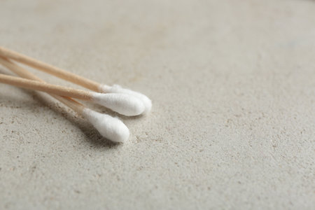 Cotton swabs on gray background, closeup. Space for textの写真素材